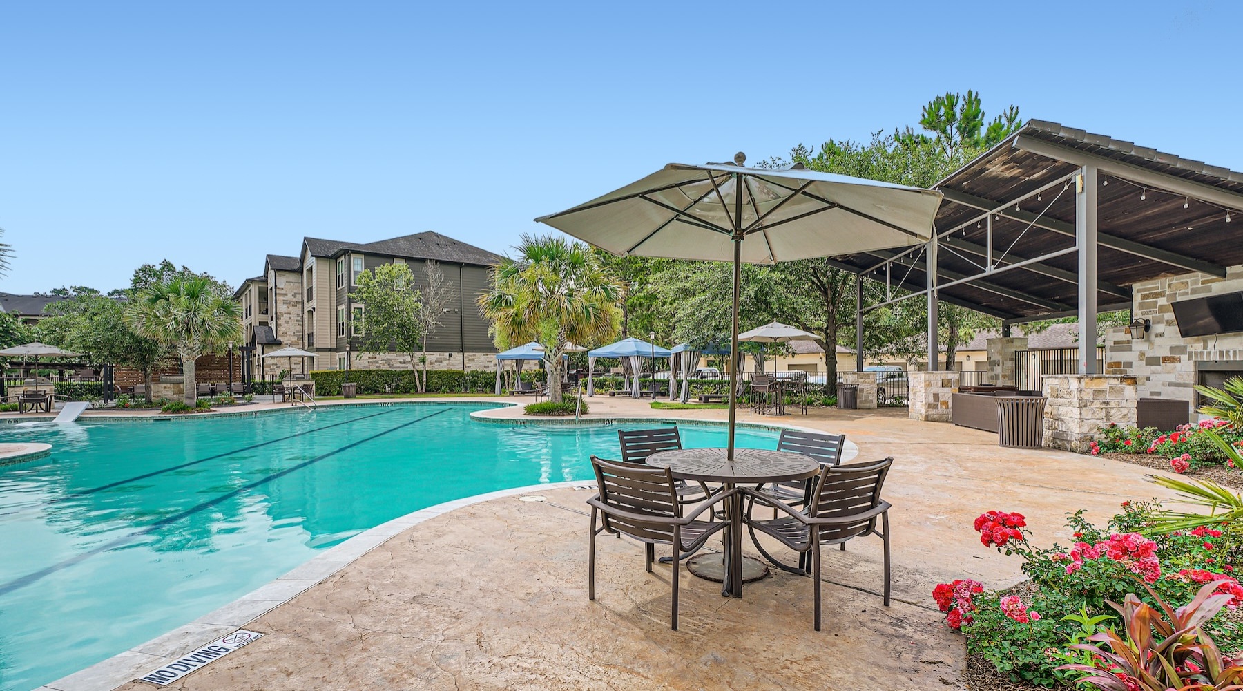 a pool with a table and chairs by it