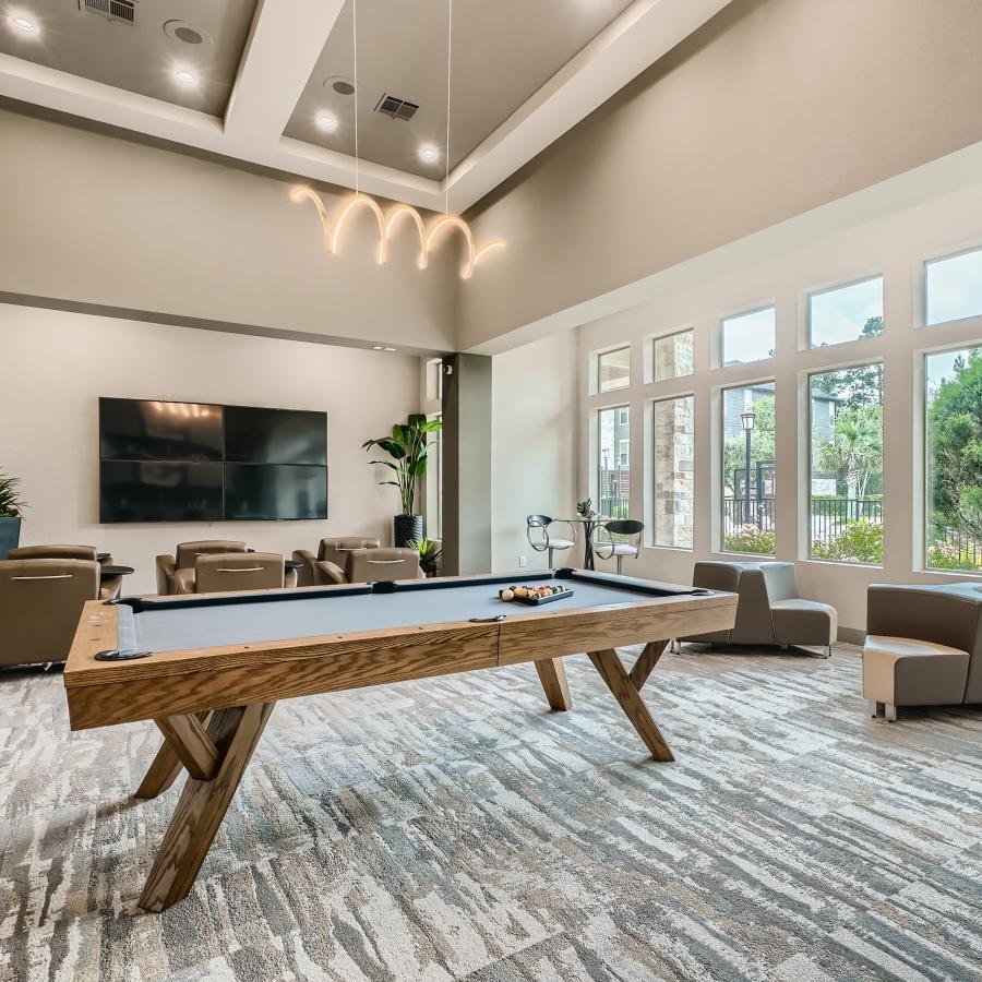 a large living room with a large table and chairs